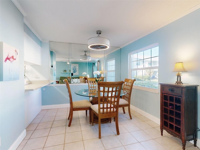 dining area with light tile patterned flooring and ornamental molding