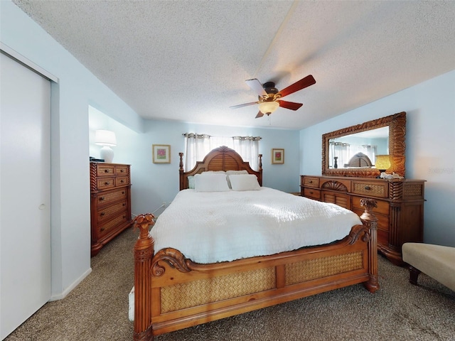 carpeted bedroom with a textured ceiling and ceiling fan