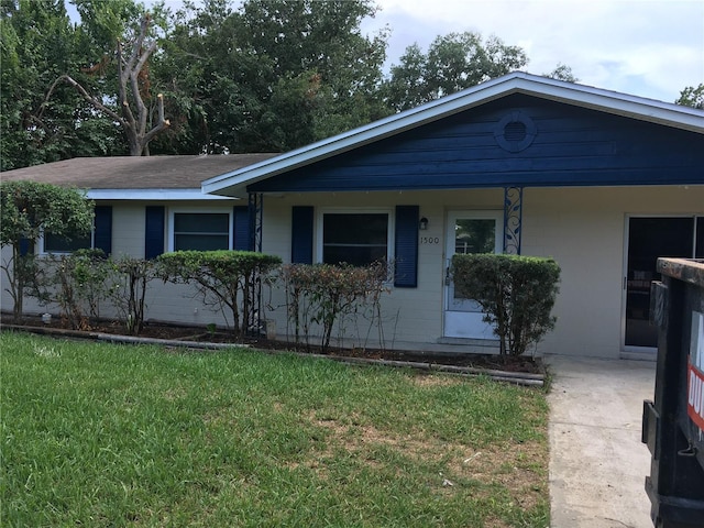 ranch-style home with a front yard and a porch