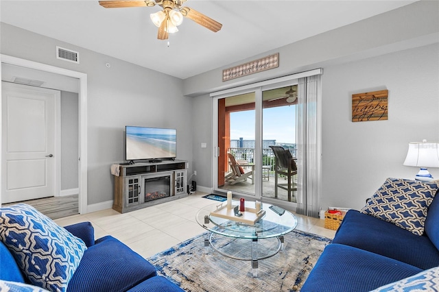 tiled living room with ceiling fan