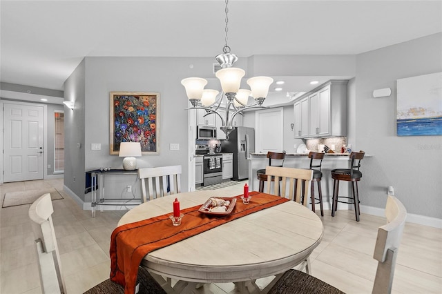 tiled dining area with a notable chandelier