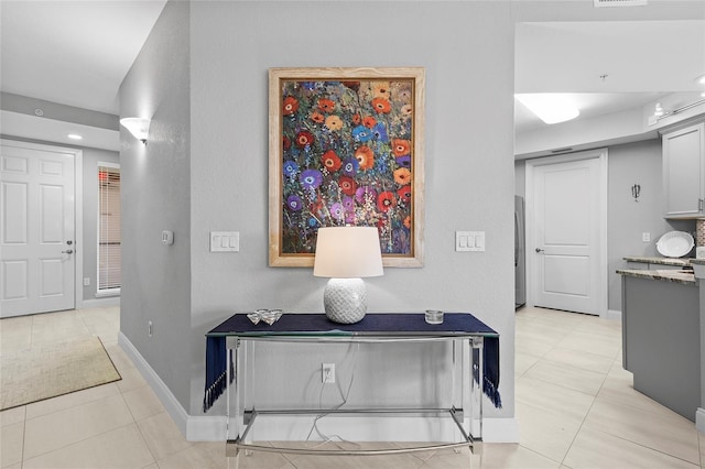 hallway with light tile patterned floors