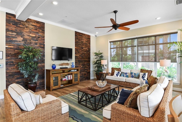 living room featuring ceiling fan, crown molding, beamed ceiling, and hardwood / wood-style flooring