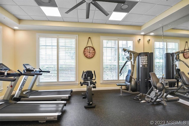 workout area featuring a paneled ceiling and a wealth of natural light