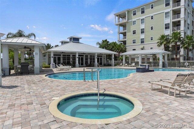 view of pool featuring a gazebo, a hot tub, ceiling fan, and a patio area