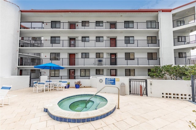 view of swimming pool featuring a patio area and a community hot tub