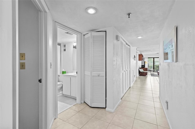 corridor with light tile patterned floors