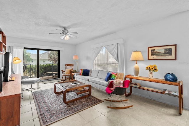 tiled living room with ceiling fan