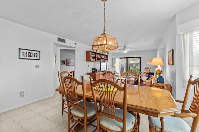 tiled dining area with ceiling fan