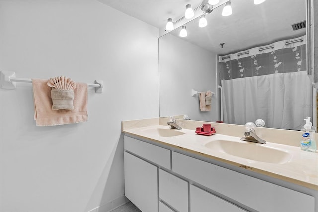 bathroom featuring tile patterned floors, a shower with shower curtain, and vanity