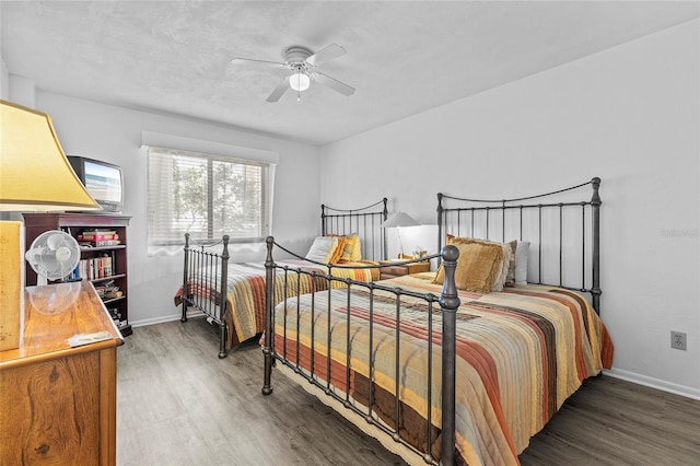 bedroom with ceiling fan and dark hardwood / wood-style flooring