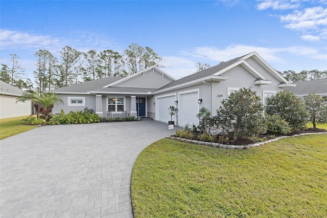 single story home featuring a garage and a front lawn