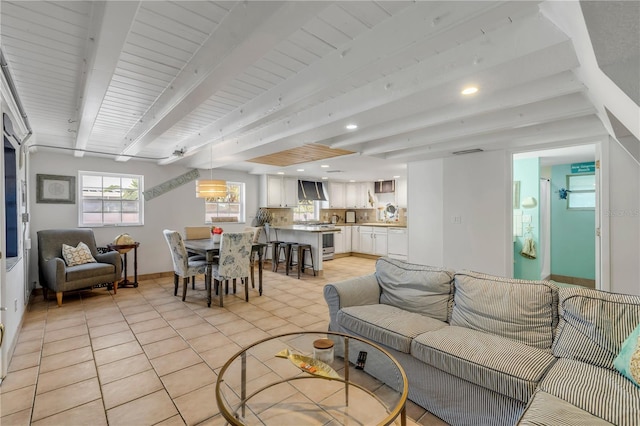 tiled living room with beamed ceiling