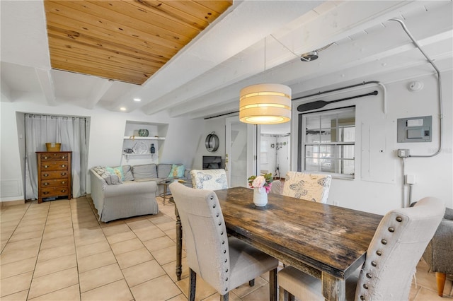 tiled dining area featuring beamed ceiling and wooden ceiling