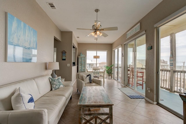 tiled living room featuring ceiling fan