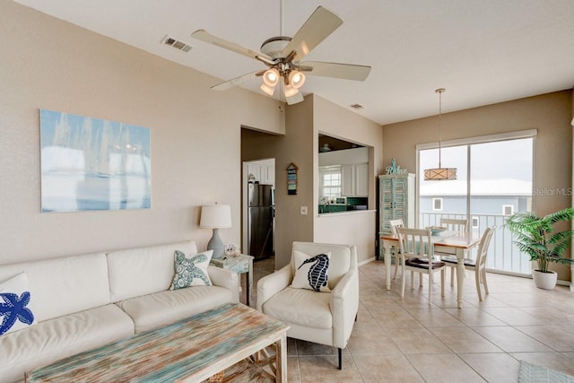 tiled living room with ceiling fan