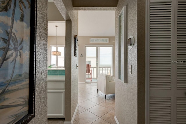 hall featuring light tile patterned floors