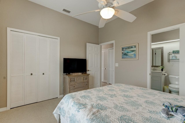 carpeted bedroom with ceiling fan and connected bathroom