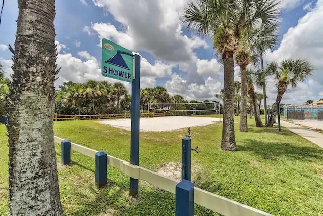 view of community featuring a lawn and volleyball court