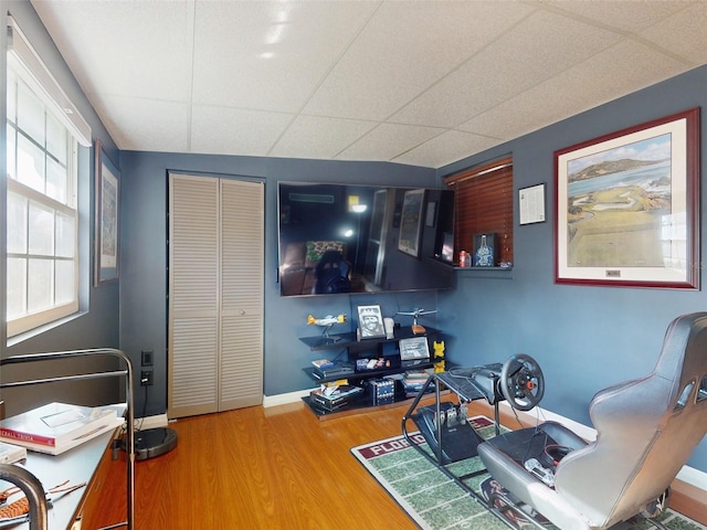 office featuring wood-type flooring and a paneled ceiling