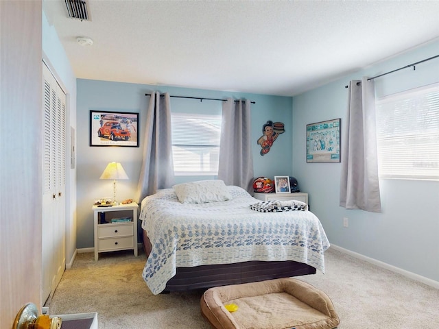 carpeted bedroom featuring a closet