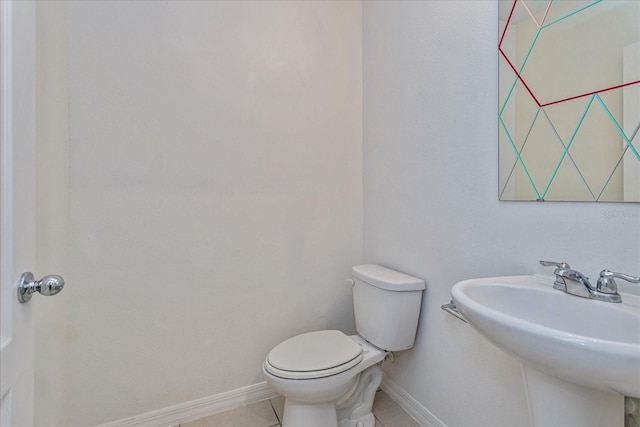 bathroom with tile patterned flooring, toilet, and sink