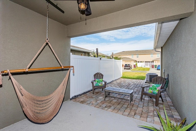 view of patio with central AC unit and ceiling fan