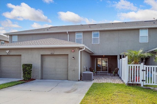 view of front of home with a patio area and central AC unit