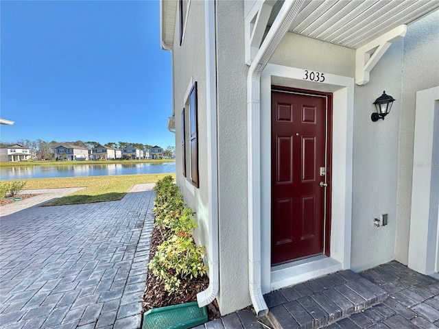 doorway to property with a water view