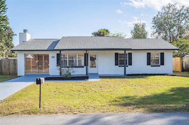18 Wildwood Dr, Edgewater, FL 32132 - ranch-style home featuring a front yard, a porch, and a carport