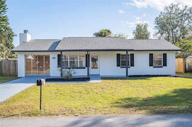 ranch-style home featuring a front yard, a porch, and a carport