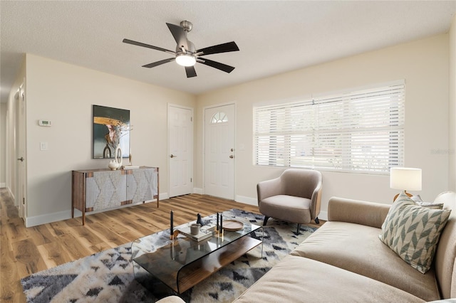 living room featuring hardwood / wood-style floors and ceiling fan