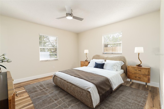 bedroom with ceiling fan and wood-type flooring