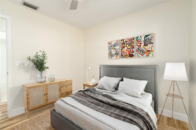 bedroom with ceiling fan and wood-type flooring