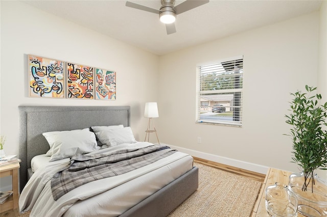 bedroom with wood-type flooring and ceiling fan