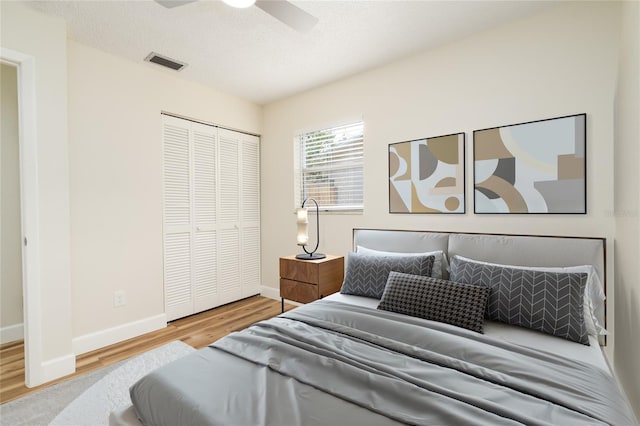 bedroom featuring wood-type flooring, a closet, and ceiling fan