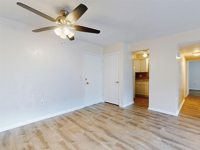 spare room featuring light hardwood / wood-style flooring and ceiling fan