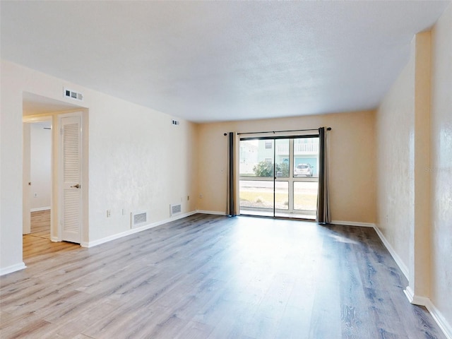 spare room featuring light wood-type flooring