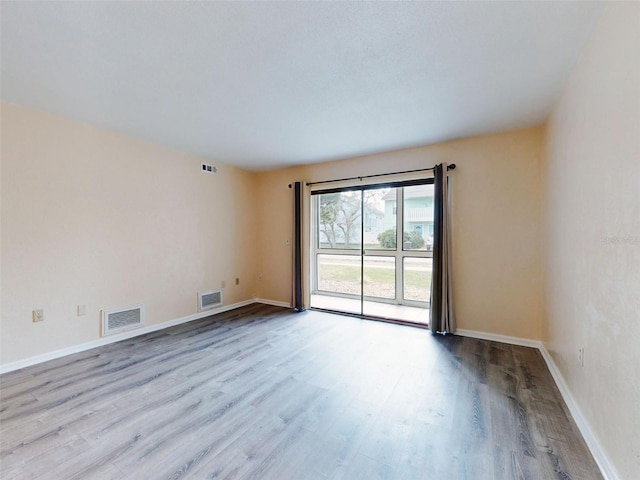 spare room with light hardwood / wood-style floors