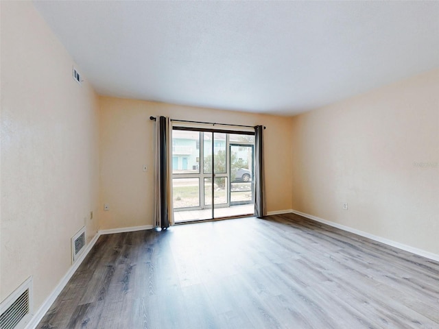 unfurnished room featuring light hardwood / wood-style floors