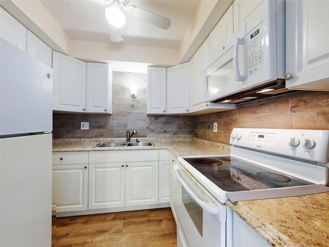 kitchen with light wood-type flooring, white appliances, ceiling fan, sink, and white cabinets