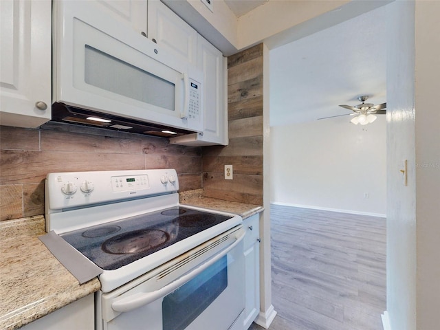 kitchen featuring white appliances, light hardwood / wood-style flooring, ceiling fan, light stone countertops, and white cabinetry