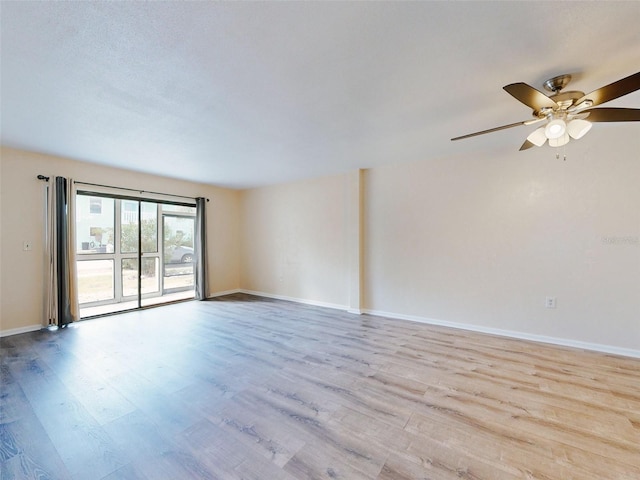 unfurnished room with light wood-type flooring and ceiling fan