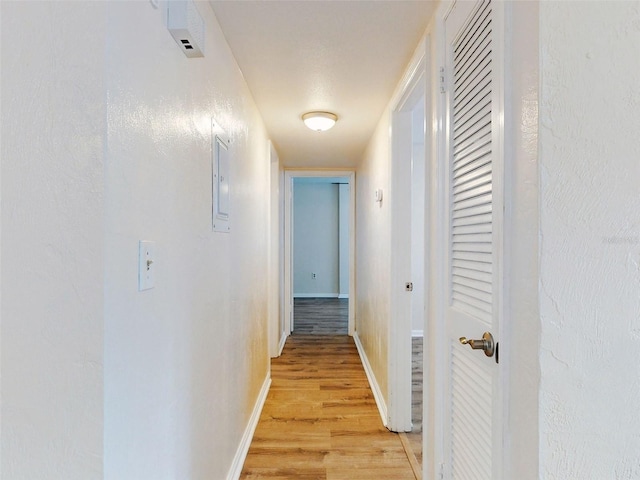 corridor with light hardwood / wood-style floors