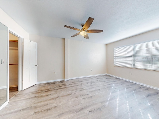 spare room with ceiling fan and light hardwood / wood-style floors