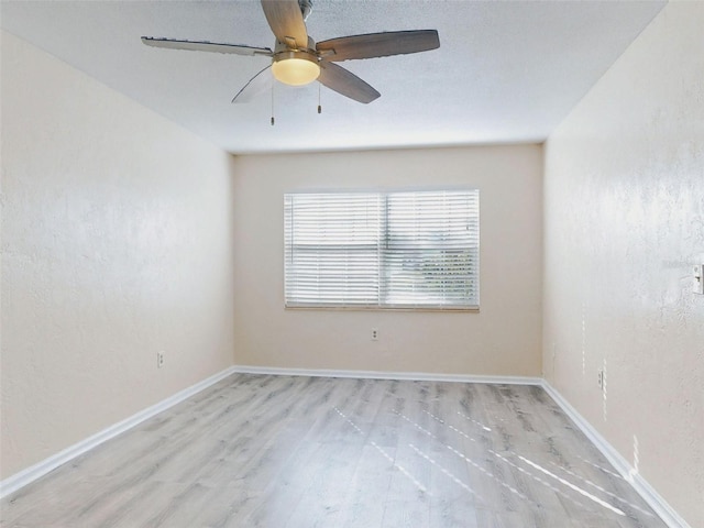 empty room with light hardwood / wood-style floors and ceiling fan