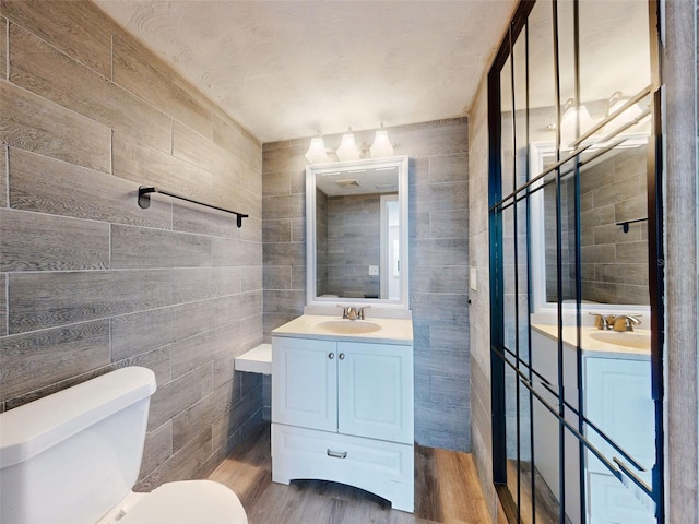 bathroom featuring hardwood / wood-style flooring, vanity, and toilet