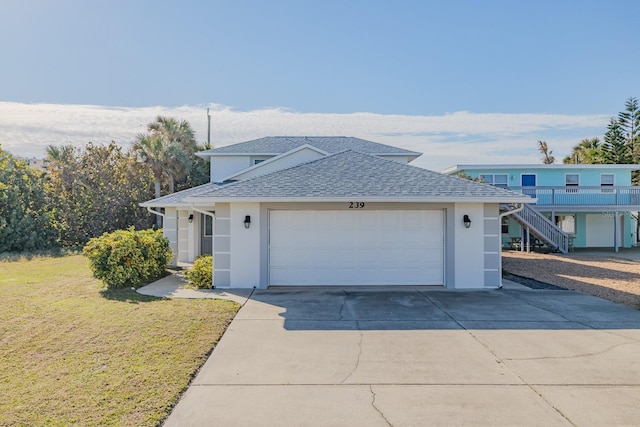 view of front of home featuring a front yard and a garage