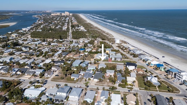 birds eye view of property with a beach view and a water view