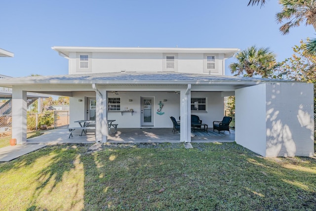 rear view of property with an outdoor hangout area, a patio area, and a yard